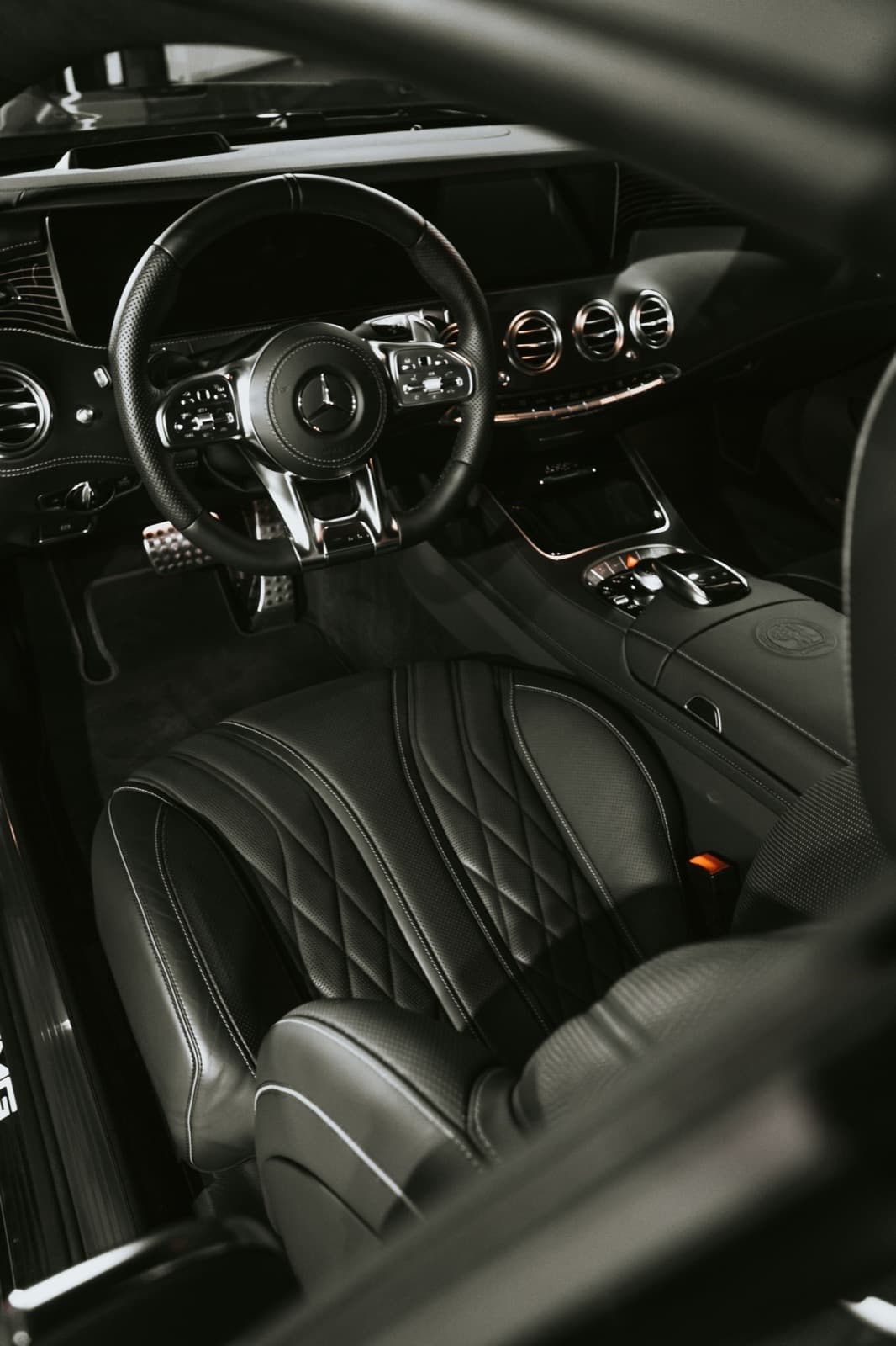 Clean black car interior with leather seats and steering wheel